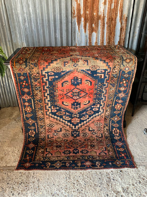 A rectangular red brown ground Persian rug