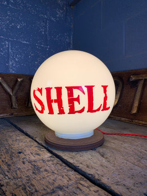 A Shell gas pump globe table lamp