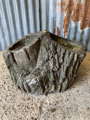 A cast stone faux bois planter