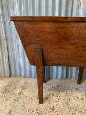 An early wooden dough bin raised on legs