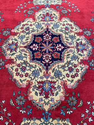 A very large red ground Kerman rug - 380cm x 281cm