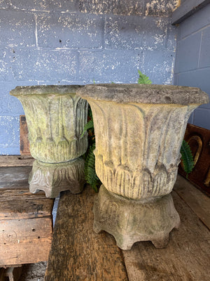 A pair of large lotus pattern cast stone urns