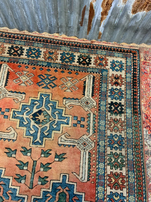 An orange and blue rectangular Persian rug