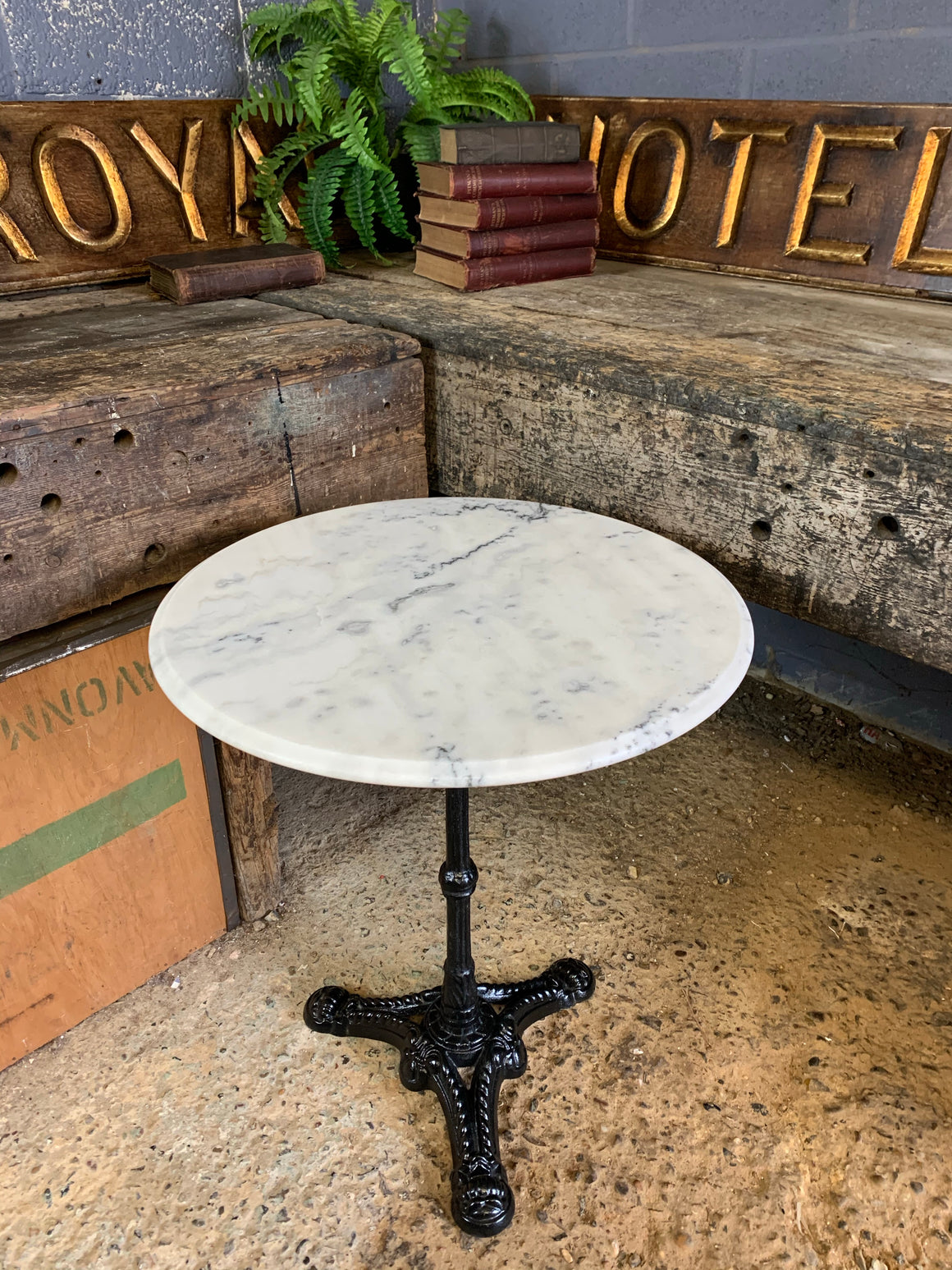 A black cast iron bistro table with marble top 2/3