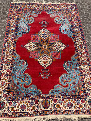 A red ground Persian rectangular rug- 188cm x 124cm