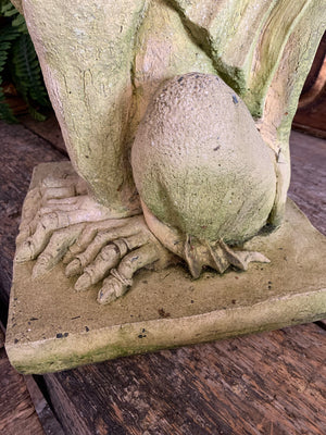 A gothic gargoyle garden statue