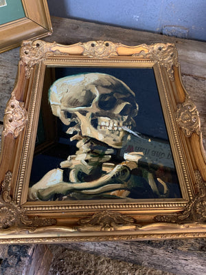 A framed and glazed print of Van Gogh's "Smoking Skeleton" (1885)