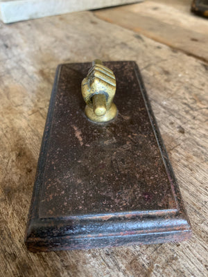 A Victorian brass and cast iron clenched fist paperweight