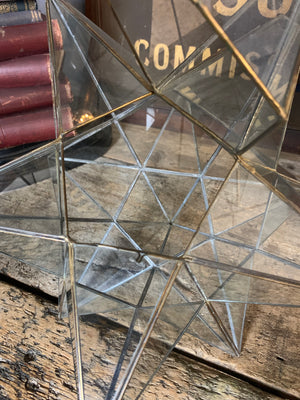 A glass and brass star ceiling light