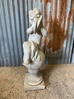 A cast stone musical putto garden statue - 88cm