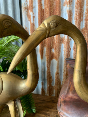 A pair of large brass Mid-Century Hollywood Regency crane statues