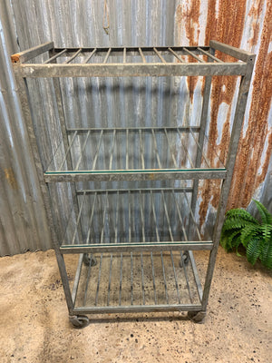 A vintage industrial steel and glass shelving unit