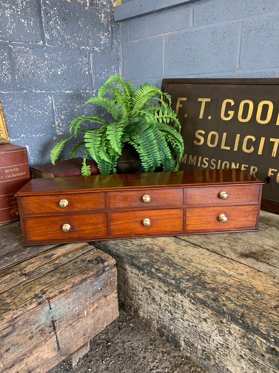 A bank of wooden table top drawers