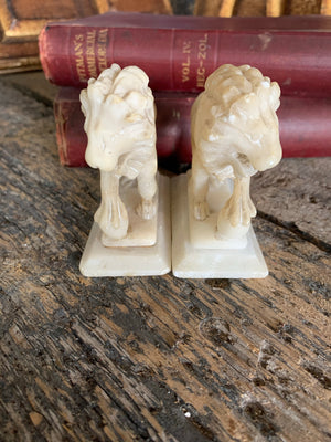 An opposing pair of Grand Tour alabaster Medici lions