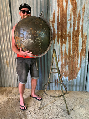 A large vintage industrial style globe drinks bar