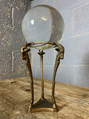 A large fortune teller's crystal ball with goat head stand