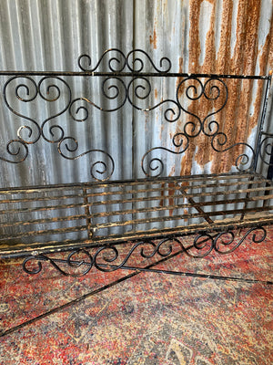 A wrought iron strapwork garden bench