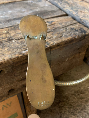 A wood and brass shoe shop display stand by Potter