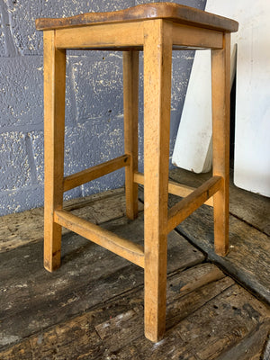 A pair of vintage wooden school laboratory stools