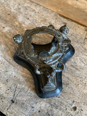 A fortune teller's crystal ball on a bronze and marble stand