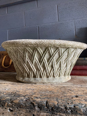 A pair of large oval lattice cast stone urns