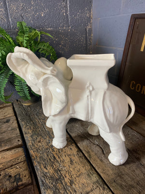A large ceramic elephant jardiniere