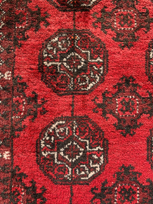 A red ground Bokhara rectangular rug- 180cm x 100cm