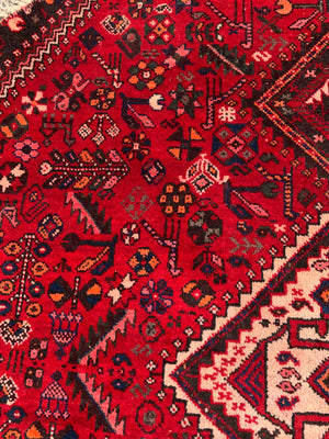 An unusual circular red ground Persian rug- 196cm