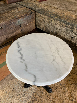 A black cast iron bistro table with marble top 3/3