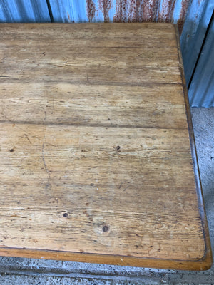 A Victorian scrubbed pine kitchen or dining table on castors