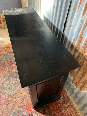 An ebonised shop counter