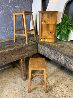 A pair of vintage wooden school laboratory stools