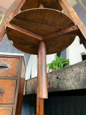 A sculptor's adjustable wooden sculpture display stand