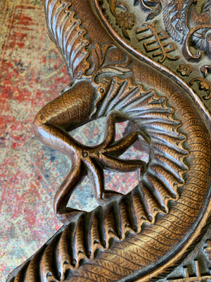 A profusely carved dragon table