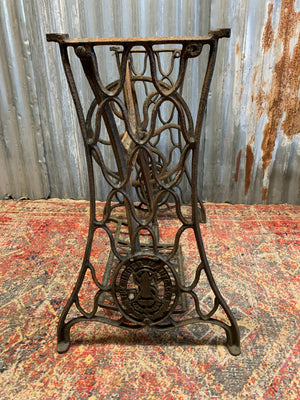 A cast iron Singer sewing table with marble top