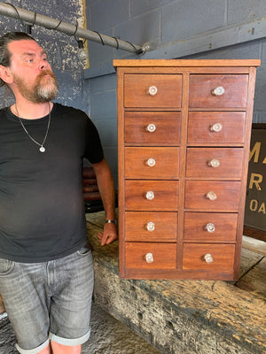 A bank of 12 apothecary drawers
