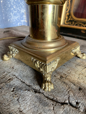 A brass column table lamp with lion paw feet