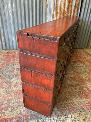 A very large bank of 45 graduated apothecary drawers