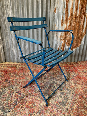 A blue cast iron French garden table and two chairs