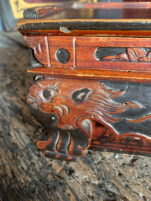 A carved wooden Chinese box with dragon motifs