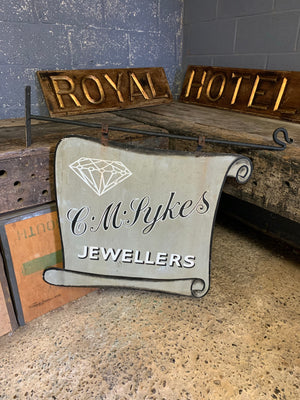 A metal trade sign for C M Sykes Jewellers