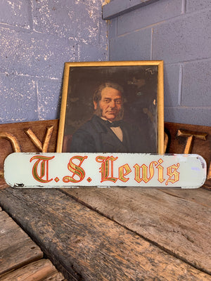 A reverse painted glass shop sign - T S Lewis