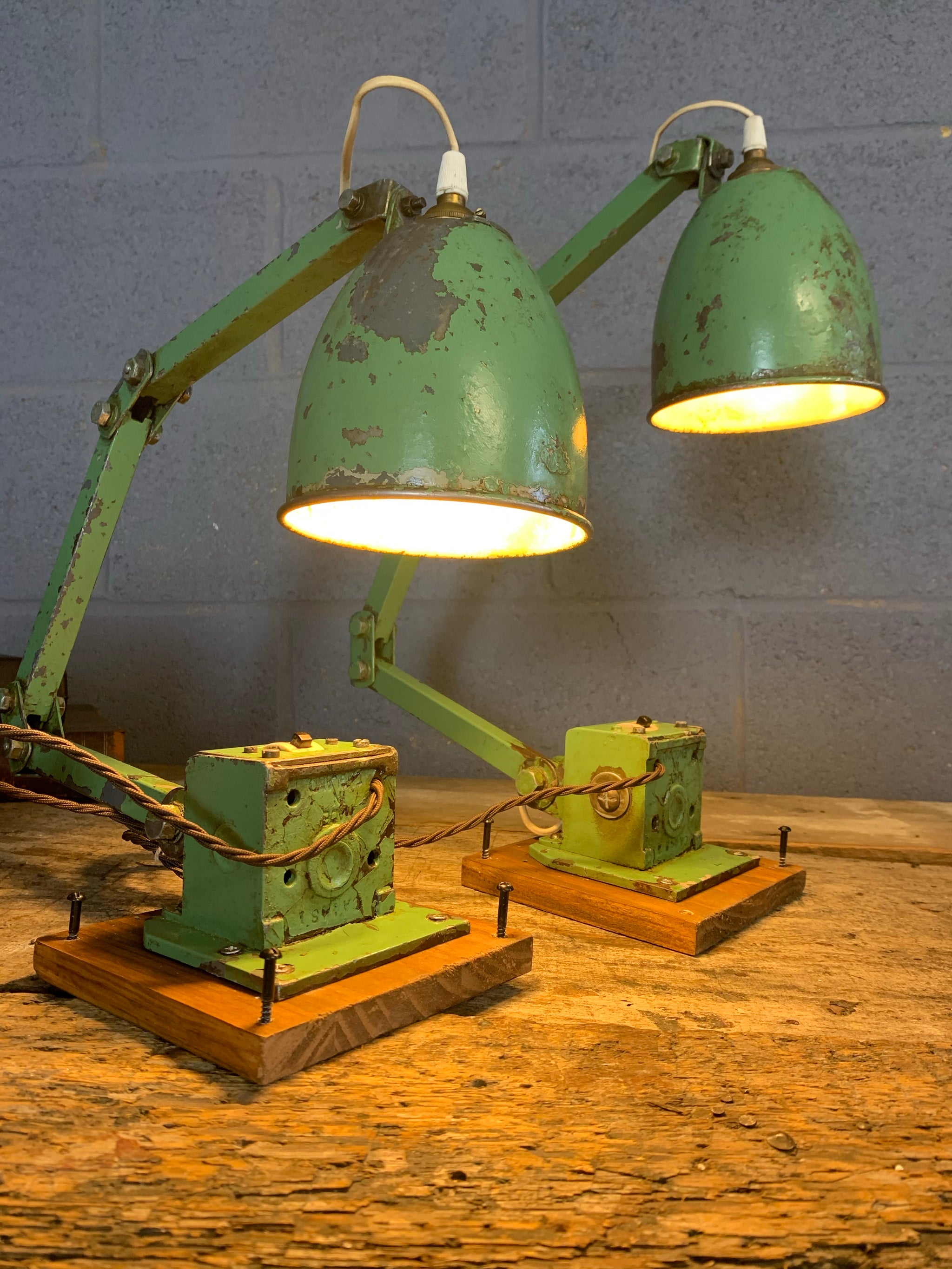 A pair of vintage industrial Memlite anglepoise lamps Belle and