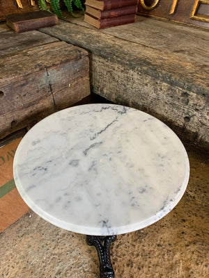 A black cast iron bistro table with marble top 2/3