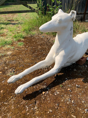 A pair of large white stone greyhound garden statues