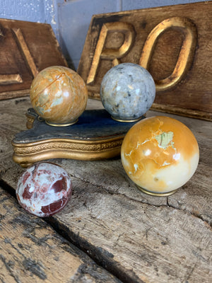 A set of four Grand Tour marble spheres