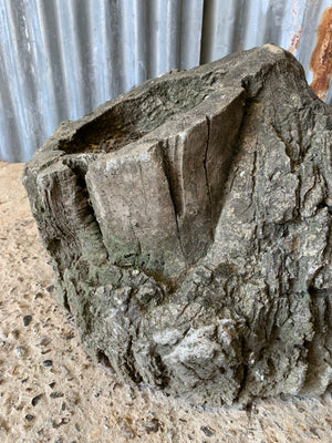 A cast stone faux bois planter