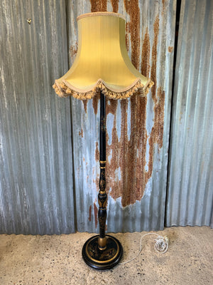 A black lacquer chinoiserie standard lamp with pagoda shade