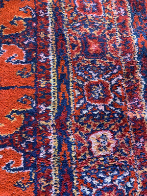 A Persian orange-red ground rectangular rug with multiple lozenge