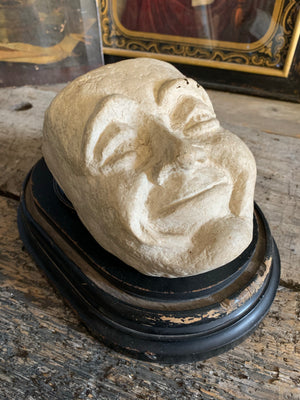 A white papier-mâché mask